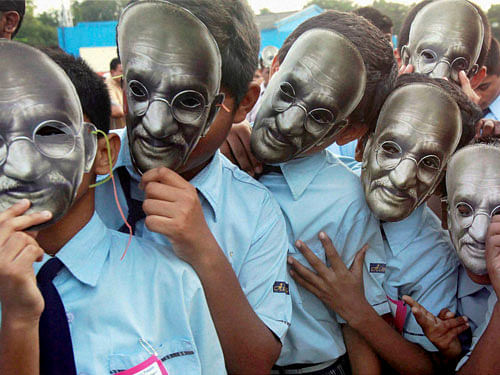 School students wear the mask of Mahatma Gandhi during a mini marathon organised on the occasion of Gandhi Jayanti in Mumbai on Friday. PTI Photo