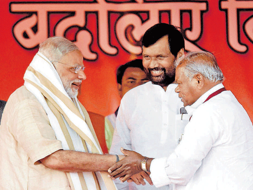 Brothers in arms : Prime Minister Narendra Modi is greeted by Jitan Ram Manjhi as LJP chief Ram Vilas Paswan looks on during an election rally in Banka on Friday. PTI