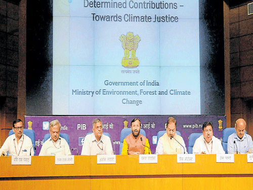 Minister of State for Environment, Forest and Climate Change Prakash Javadekar (C) outlines the plan to tackle climate change at a press conference in New Delhi on Friday. AFP