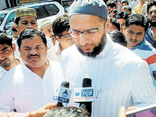 MIM chief Asaduddin Owaisi talks to the media after meeting Danish, Akhlaq's son, at a hospital in Noida on Friday. PTI