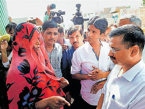 A woman stops Delhi Chief Minister Arvind Kejriwal and AAP leaders Kumar Vishwas and Sanjay Singh from entering Bisara village in Dadri on Saturday. PTI Photo