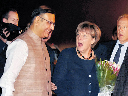 Merkel begins India tour: German Chancellor Angela Merkel being received by Minister of State for Finance Jayant Sinha on her arrival at the Air Force Station Palam in New Delhi on Sunday.  PTI photo