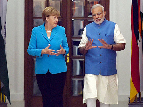 PM Modi with German Chancellor Angela Merkel before a meeting at Hyderabad House in New Delhi on Monday. PTI Photo