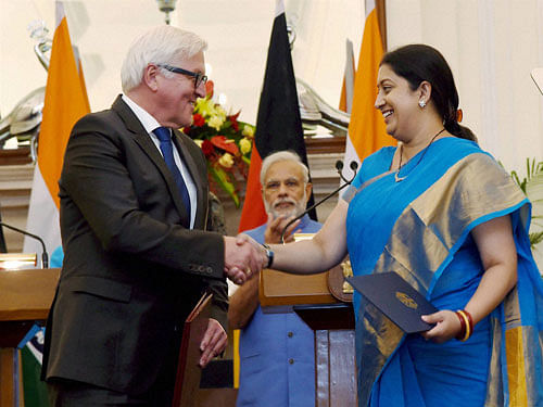 Union HRD minister Smriti Irani exchanges agreement documents with German Foreign Minister Frank-Walter Steinmeier at Hyderabad House in New Delhi on Monday. PTI Photo