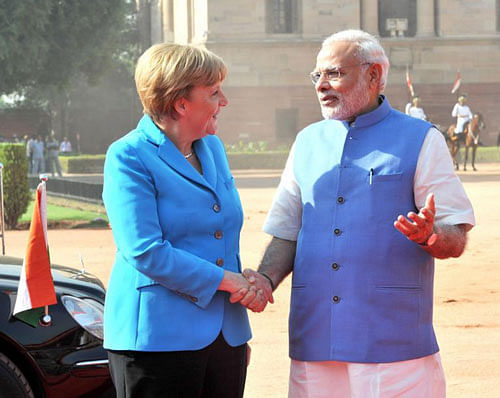 Prime Minister Narendra Modi with German Chancellor Angela Merkel in New Delhi on Monday. PTI Photo