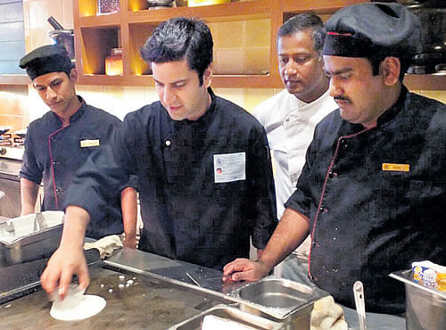 Kunal Kapur checking dosa batter for the high-profile lunch.