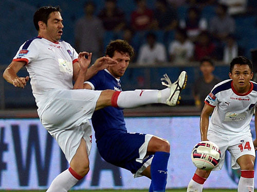 Delhi Dynamos FC Anderson Sebastiao Cardoso(4) vies for the ball with Chennaiyin FC (blue jersey Elano Blumer during their Indian Super League (ISL) match at Jawaharlal Nehru Stadium in New Delhi on Thursday. PTI Photo