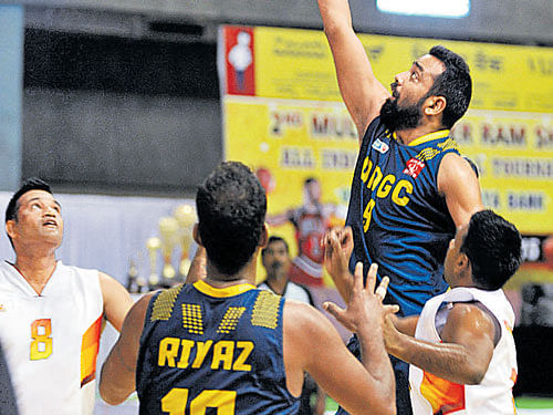 ONGC captain Vishesh Bhriguvanshi attempts a lay-up as Karnataka players try to stop him in theMulki Sunder RamAll-India Basketball tournament. DH PHOTO