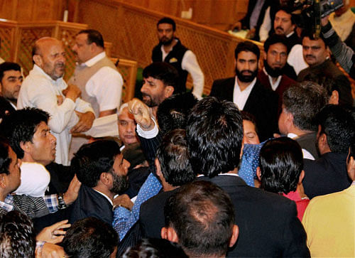 BJP MLAs attack independent MLA Sheikh Abdul Rashid for his Wednesday's Beef Party as National Conference and Congress MLAs try to save him, during Autumn session of the Assembly in Srinagar on Thursday. PTI Photo