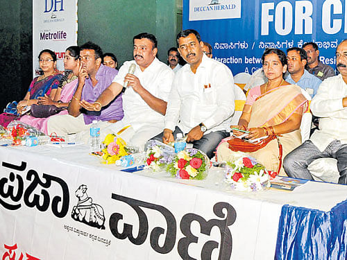Basavanagudi MLA Ravi Subramanya speaks during Citizens for Change organised by Deccan Herald and Prajavani at Kempegowda National Indoor Stadium, Basavanagudi on Friday.  (L-R): Corporators Shyamala Kumar (Vidyapeeta), M Savitha, (Srinagar), Sangathi Venkatesh, (Kathriguppe), Kempegowda, (Hanumanthanagar), A V Nandini Vijay Vittal (Girinagar), B S Satyanarayana (Basavanagudi), Kenchappa Gowda, EE, BBMP, and Ramaratha Kumar, SI, Basavanagudi traffic police station, are seen. dh photo