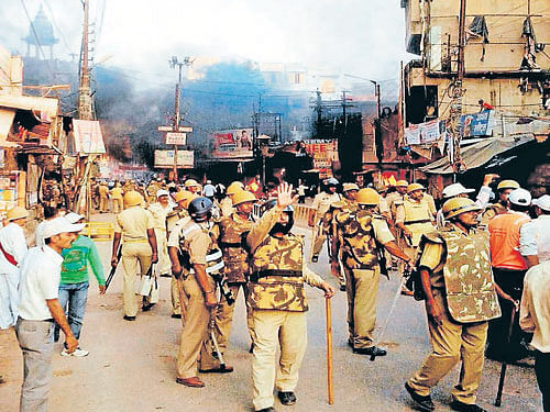 Rumours again: Police try to bring the situation under control after people vandalised properties and resorted to arson at Karhal in the Mainpuri district of Uttar Pradesh on Friday. PTI Photo