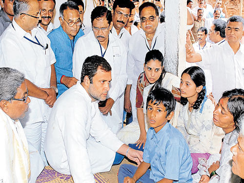 Congress vice-president Rahul Gandhi speaks to the kin of Lokesh, a farmer who ended his life due to debt in Mandya district, on Friday. Chief Minister Siddaramaiah, actor-turned-politician Ramya, Housing Minister M H Ambareesh and KPCC chief G Parameshwara look on. DH Photo