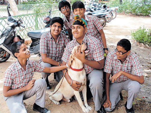 Dr Ruffles, a labrador, with children at Saraswathi Kendra at the campus of the  C P Ramaswamy Aiyar Foundation in Chennai.
