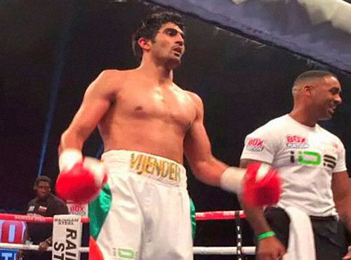 Indian boxer Vijender Singh celebrates after winning the match against England's Sonny Whiting during first professional boxing bout at Manchester Arena, UK on Saturday. PTI Photo