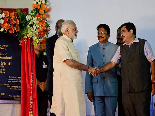 Prime Minister, Narendra Modi greets the Union Shipping and Transport Minister, Nitin Gadkari during the ceremony of laying a foundation stone of the 4th container terminal at Jawaharlal Nehru Port Trust near Mumbai on Sunday. PTI Photo