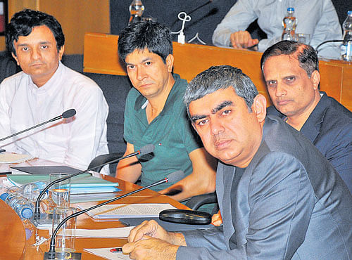 Infosys CEO and MD Vishal Sikka (front) reacts to a query at the company's quarterly results in Bengaluru on Monday, as colleagues (from right) COO U B Pravin Rao, Executive VP and outgoing CFO Rajiv Bansal, and Executive VP and incoming CFO MD Ranganath look on. DH PHOTO