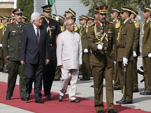 Palestinian President Mahmoud Abbas, left, and Indian President Pranab Mukherjee review the honor guard upon Mukherjee's arrival in the West Bank city of Ramallah, Monday, Oct. 12, 2015.PTI Photo