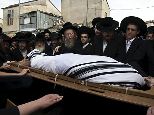 Ultra-Orthodox Jews carry the body of Yeshayahu Krishevsky during his funeral in Jerusalem's Mea Shearim neighbourhood. Reuters