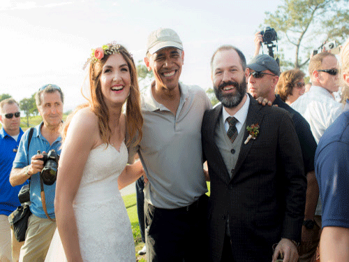 Stephanie Mirkin (L) and Brian Tobe (R) are pictured with U.S. President Obama Obama during their wedding at The Lodge at Torrey Pines in La Jolla, California October 11, 2015. President Barack Obama played an unexpected starring role in a Southern California wedding over the weekend when he ended a round of golf and posed for photos with a bride and groom. Reuters Photo.