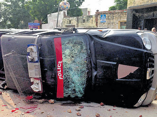 A damaged police vehicle after clashes in Faridkot onWednesday. PTI