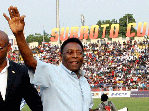 Brazilian football legend Pele waves to his fans before the start of the Under-17 boys final match of the Subroto Cup as Chief Guest at the Ambedkar Stadium in New Delhi on Friday. PTI Photo.