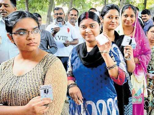 Voterswait in queues to exercise their franchise during Phase II of Bihar elections in Gaya on Friday. PTI