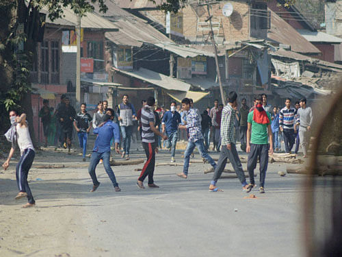 Kashmiri youths pelting stones on police and paramilitary forces protesting against death of a trucker who was injured when a mob set his vehicle afire in Udhampur, pti photo