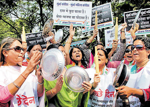 Congress workers stage 'Thali-Latne' protest against rise in the price of pulses in Mumbai on Tuesday. PTI