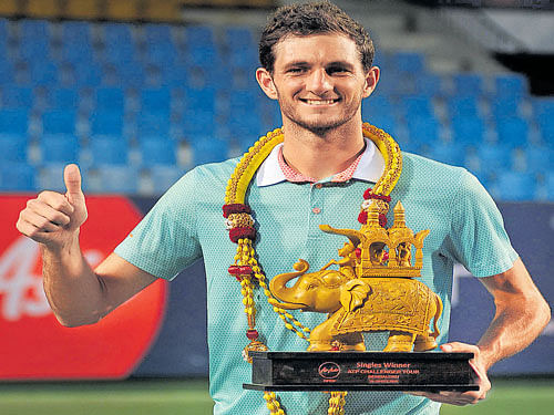 winning smile: Britain's James Ward poses with his spoils after his title triumph in Bengaluru on Sunday. dh photo