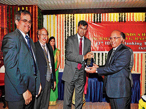 Karnataka Bank Managing Director P Jayarama Bhat seen  receiving the IDRBT Award from Reserve Bank of India  Governor Dr Raghuram G Rajan in Hyderabad. DH photo
