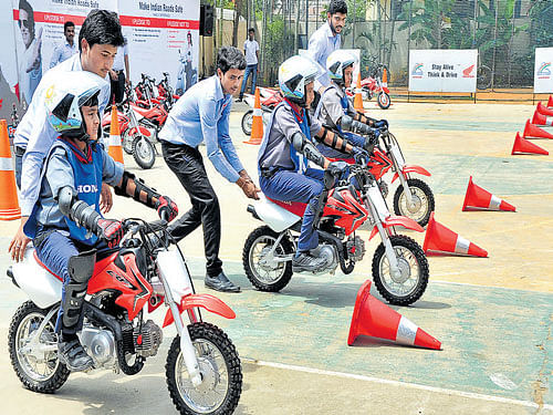 Schoolchildren take part in Honda CRF 50 Fest, an initiative to create road safety awareness at the Alpine School on Kanakapura Road on Wednesday. DH PHOTO