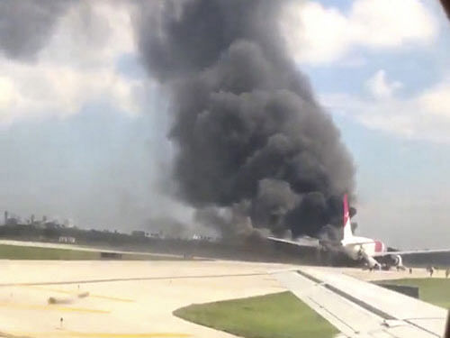 A still image from a handout video footage by Mike Dupuy, a passenger in another airplane, shows Dynamic International Airways' Boeing 767's engine on fire in Fort Lauderdale, Florida. Reuters photo