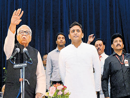 Uttar Pradesh Governor Ram Naik gestures to the band to stop playing the National Anthem as Akhilesh Yadav looks on, during the swearing in ceremony in Lucknow on Saturday. PTI photo