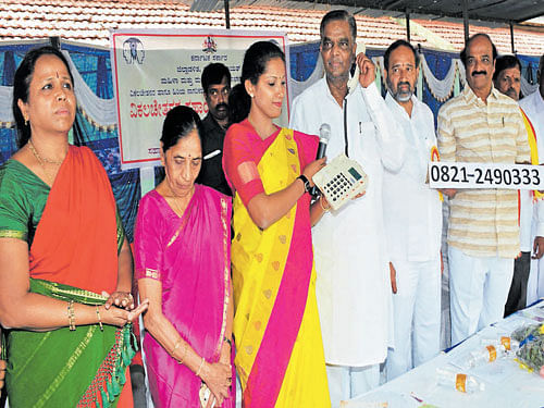 Revenue and&#8200;District In-charge Minister&#8200;V&#8200;Srinivas Prasad makes a call at the launch of a helpline for specially-abled persons in Mysuru on Sunday.&#8200;Mayor R&#8200;Lingappa, Deputy&#8200;Mayor&#8200;Mahadevamma,&#8200;ZP President Pushpa Amarnath, MUDA&#8200;Chairman K&#8200;R&#8200;Mohan Kumar Deputy Director, Women and Child Development&#8200;Department K&#8200;Radha are seen. DH&#8200;photo