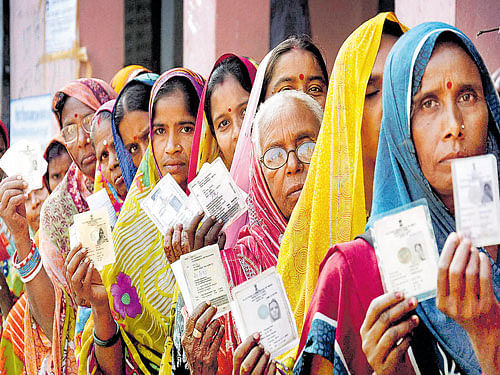 Women wait to cast their votes during the fourth phase of Bihar elections in Muzaffarpur on Sunday. PTI photo