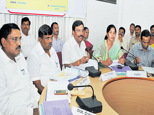 Chairman of the Legislative Committee on Welfare of SC/STs P M Narendraswamy speaks  at a review meeting at the DC's office in Mysuru on Monday. MLAs Raja Venkatappa and  Thimmarayappa, Deputy Commissioner C Shikha and Police Commissioner B Dayananda  are seen. DH photo