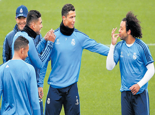IN RELAXED MOOD: Rea lMadrid's Cristiano Ronaldo (centre) shares a light moment with team-mates Danilo (left), Casemiro (second from left) and Marcelo (right) during a training session in Madrid on Monday. REUTERS