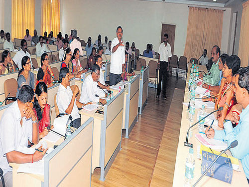 A member raises a point at a Zilla Panchayat meeting in Udupi on Tuesday. DH photo