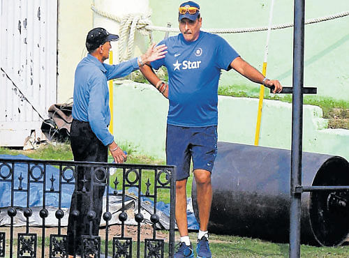 HOT TOPIC! TeamIndia director Ravi Shastri (right) discusses a point with curator Daljit Singh during Tuesday practice session at Mohali. PTI