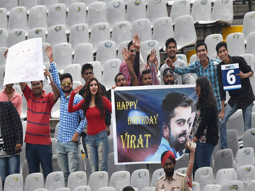 Fans wishing Happy Birthday to Indian skipper Virat Kohli during the first day of the first cricket test match against South Africa in Mohali on Thursday. PTI Photo.