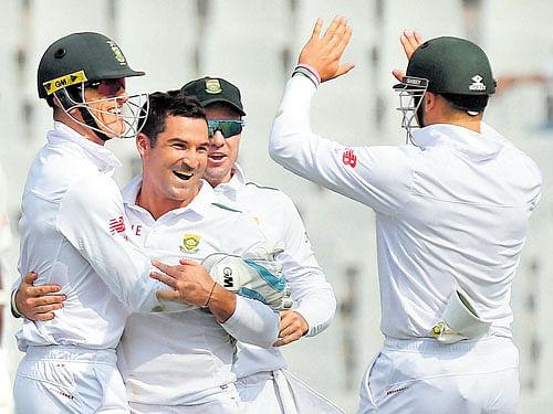 unlikely hero: South Africa's Dean Elgar (second from left) celebrates with team-mates after dismissing Wriddhiman Saha on Thursday. PTI