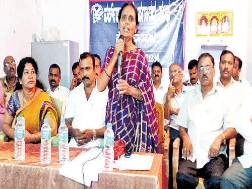 Somwarpet Town Panchayat President Leela Nirvani speaks during the meeting held regarding the workshop area clearance on Thursday. DH photo