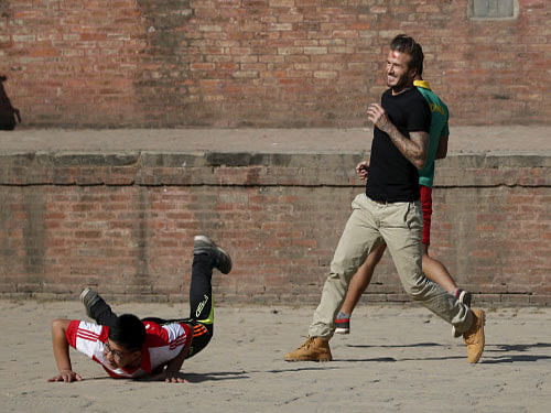 David Beckham plays soccer with children during the charity match to collect funds for the United Nations Children's Fund (UNICEF) at the ancient city of Bhaktapur, Nepal. Reuters photo