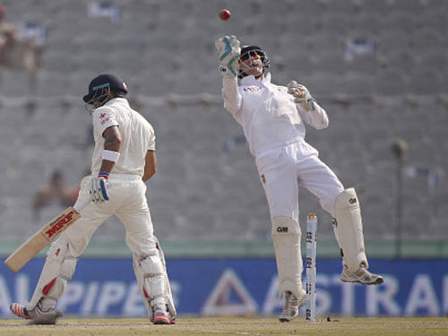 South Africa's wicketkeeper Vilas celebrates after taking a catch to dismiss India's captain Kohli during the third day of their first cricket test match, in Mohali. Reuters photo
