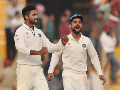 India's bowlers Ravindra Jadeja and captain Virat Kohli celebrate after winning the first test match against South Africa in Mohali on Saturday. PTI Photo.