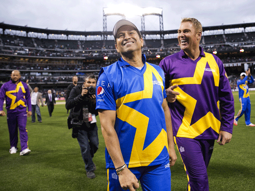 Sachin Tendulkar (L) and Shane Warne (R) walk around the field after a Cricket All-Star exhibition match at Citi Field in New York, November 7, 2015. The event was the first of three games to be played for the first time in American baseball parks.  Reuters