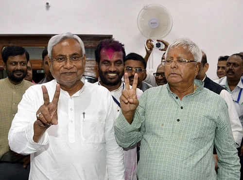 Nitish Kumar, leader of Janata Dal (United) and Chief Minister of Bihar, and Lalu Prasad Yadav, chief of Rashtriya Janata Dal, gesture after addressing a news conference in Patna. Reuters photo