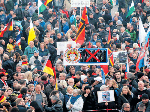 up in arms: An anti-immigration protest in Dresden, Germany. The collective optimism generated by Chancellor Angela Merkel's open-door policy for refugees has soured. Ominous street protests, outfitted with mock guillotines, are now almost daily occurrences. Reuters