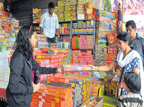 Customers are spoilt for choice at a crackers stall in Malleswaramon Sunday. DH PHOTO