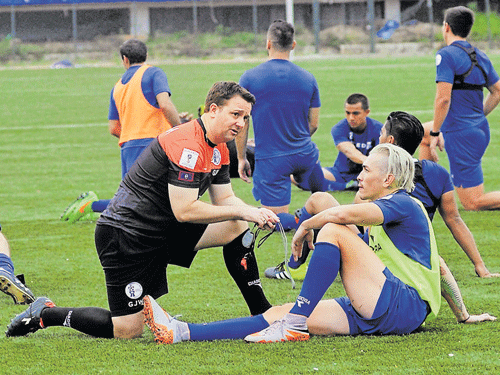 gearing up Guam's coach's Gary White (left) has a word with one of his players during a training session at the Bangalore Football stadium on Sunday. DH photo/ kishor kumar bolar